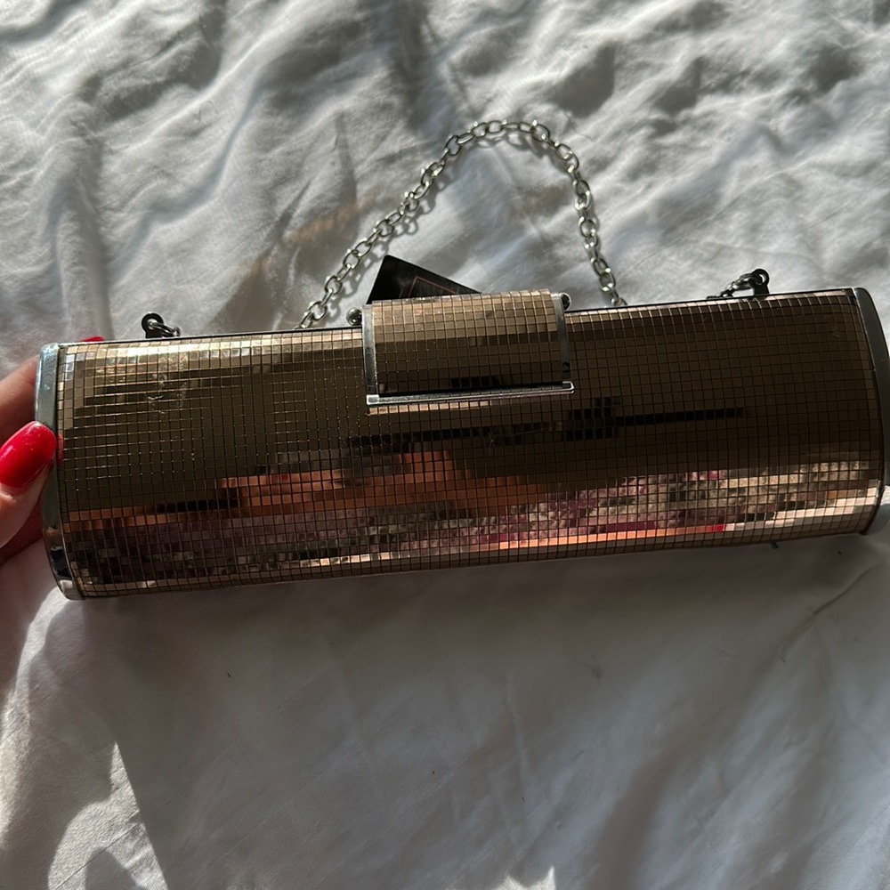 Brand new BCBG Maxazria bronze clutch with chain handle.